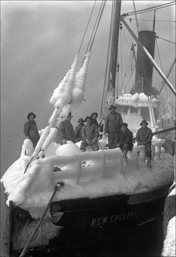 B&W of men on ice covered boat