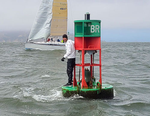 Man standing on Blossom Rock buoy.