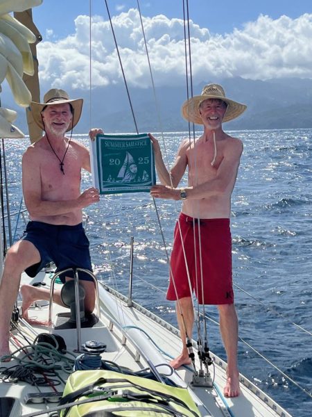 Ken Austin and Tom Neukranz 'hiost' their Summer Sailstice burgee as they arrive in Hiva Oa aboard Ken's J/40 Mimosa on the Sailstice.
