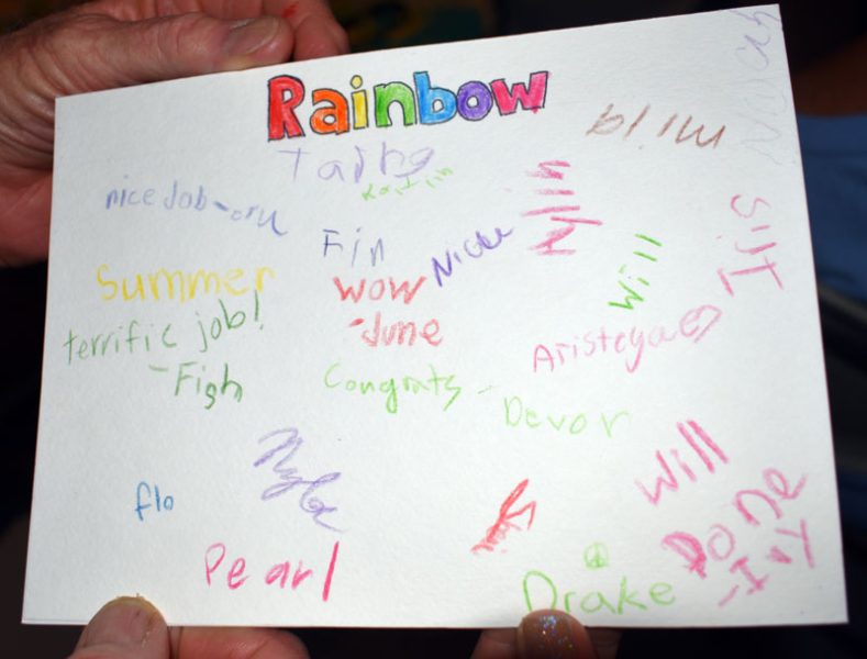 Rainbow's card signed by kids