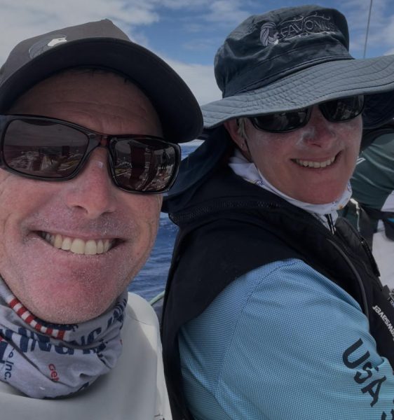 Matthew Sessions and boat captain Ashely Perrin review the day's repairs on the rail of Favonius2.