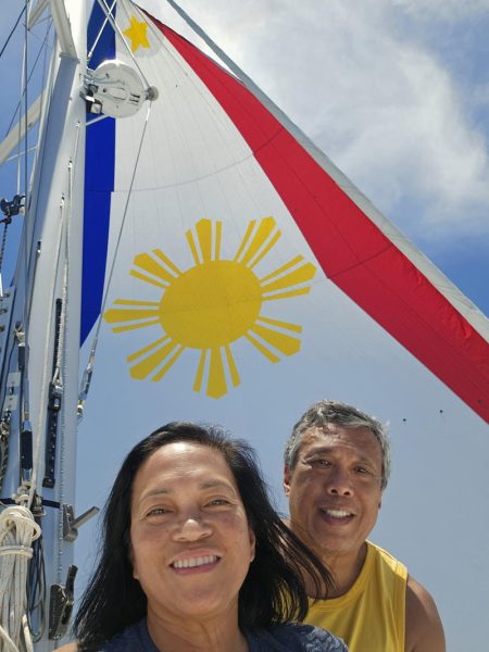 Diana and Joaquin under the spinnaker aboard Rising Sun. 