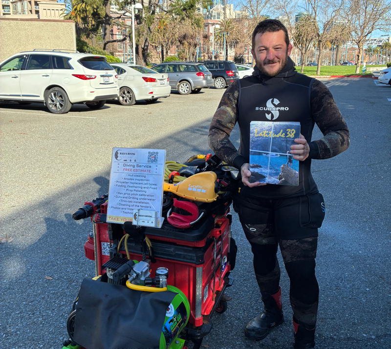 Our undercover agent, Bob Bodnar, grabbed this shot of diver Cayo of Maia's Diving with the new March issue just before he went under at Pier 40.