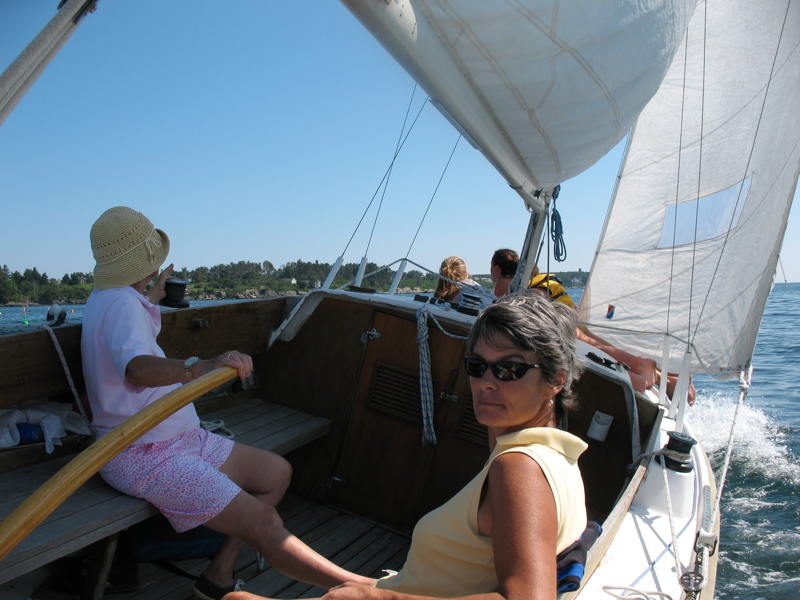 Grandma at the helm, mom at the sheets and granddaughters on the bow.