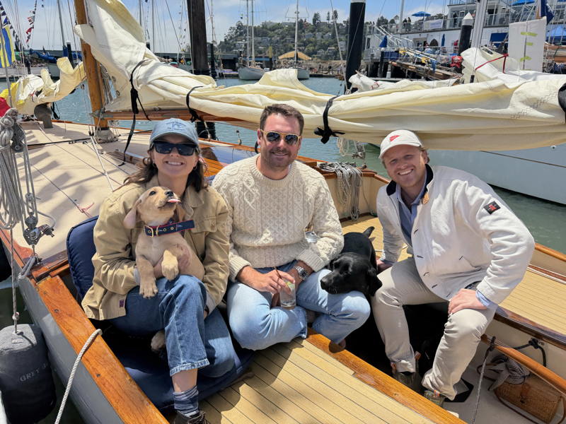 Marie Bergsund, Miles Daly and Josh George (left to right). Hallie the yellow lab and Piper the black lab. New owners of Grey Goose, purchased for one dollar!