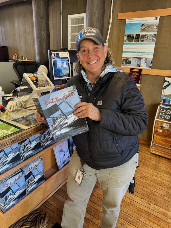 Smiling woman holding Latitude 38 magazine