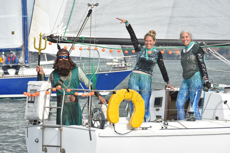 Sailors in sea myth costumes with pumpkin string lights