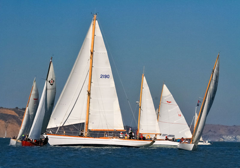Classic wooden boats on opposite tacks