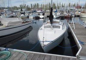 A spider web of dock lines keeps the boat nesting off the dock. Note: This is Dorado, hull #242, built in 1963, and one of the first three Thunderbird sailboats to arrive in Port Townsend that year, starting the fleet that still races today. Jim Daubenberger commissioned her, and she has been in the family since, presently stewarded and raced by his grandson, Hans.
