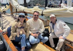 Marie Bergsund, Miles Daly and Josh George (left to right). Hallie the yellow lab and Piper the black lab. New owners of Grey Goose, purchased for one dollar!