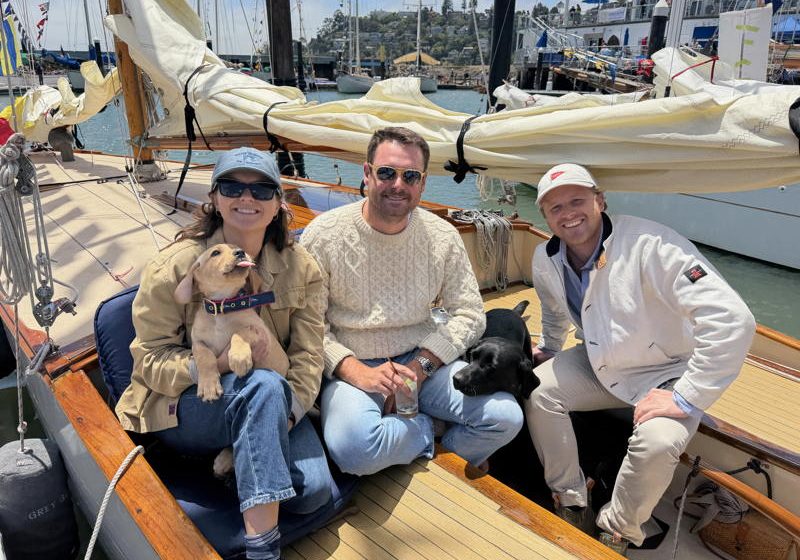 Marie Bergsund, Miles Daly and Josh George (left to right). Hallie the yellow lab and Piper the black lab. New owners of Grey Goose, purchased for one dollar!
