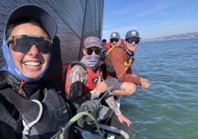 Santa Cruz 40 "Quiver" crew Ros, Mateo, Dan and Blake hanging loose on the low side. Berkeley Midwinters Race #1, Saturday, Nov 9, 2024. Photo credit: Ros de Vries - Sailagram - 11