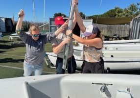 Stepping the mast is a group effort.