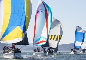 A colorful spinnaker lineup racing downwind at the 2026 Express 37 Nationals. 