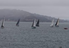 One of the first groups of Pacific Cup racers makes their way through the fog towards the Golden Gate on Monday. 